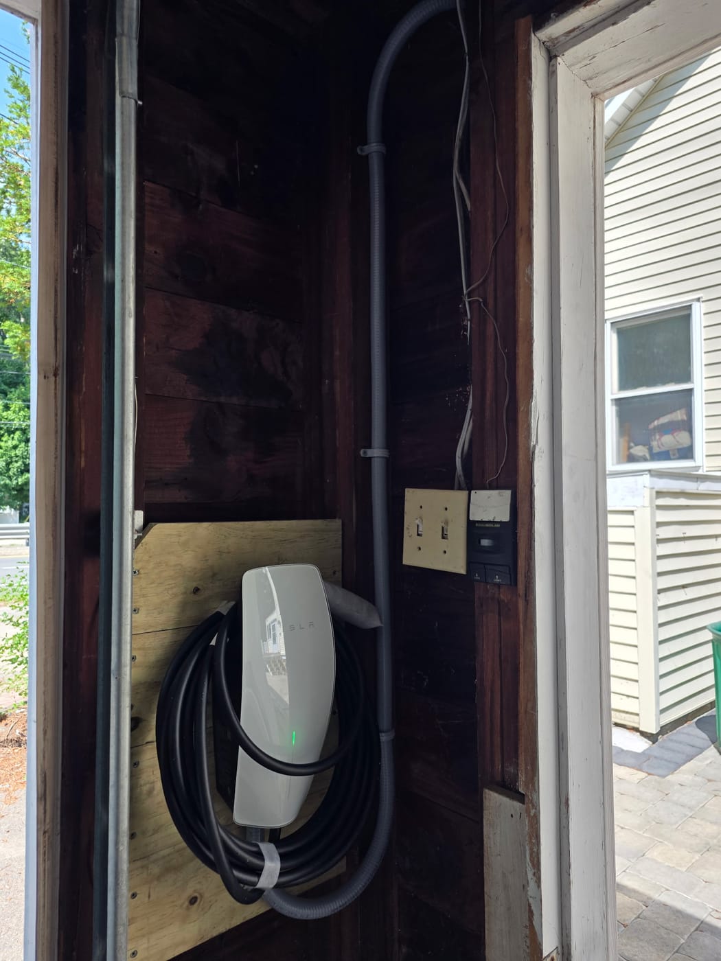 Tesla Wall Connector installed by Powered Up LLC — home EV charger with dedicated circuit and conduit run