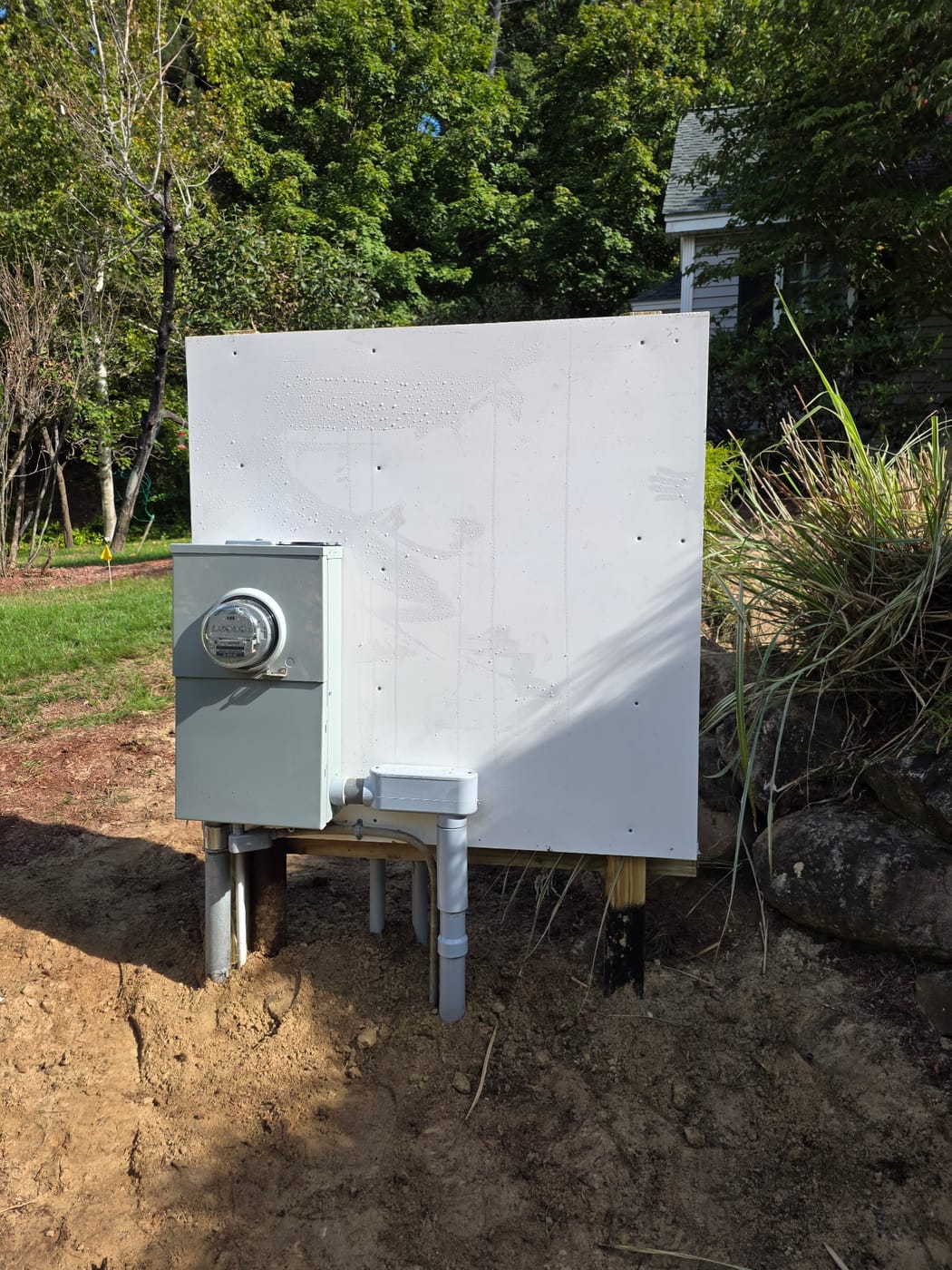 Finished freestanding meter pedestal by Powered Up LLC — meter socket on a post-mounted board with underground conduit to grade